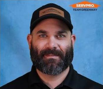 male employee wearing a black SERVPRO shirt 