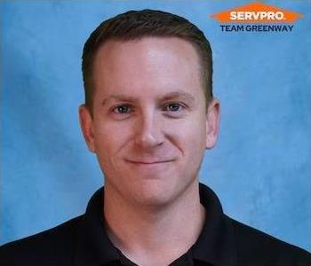 male employee wearing a black SERVPRO shirt 