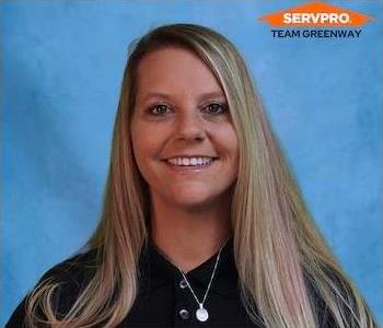 female employee with blond hair wearing a black shirt