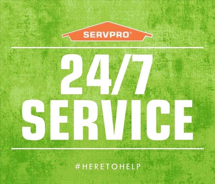 SERVPRO orange house and 24/7 service written on a green background