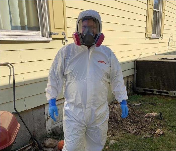SERVPRO employee wearing a white PPE suit