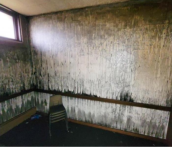 smoke and soot damage on walls of fire damaged room