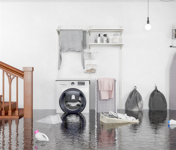 a flooded laundry room with water covering the floor