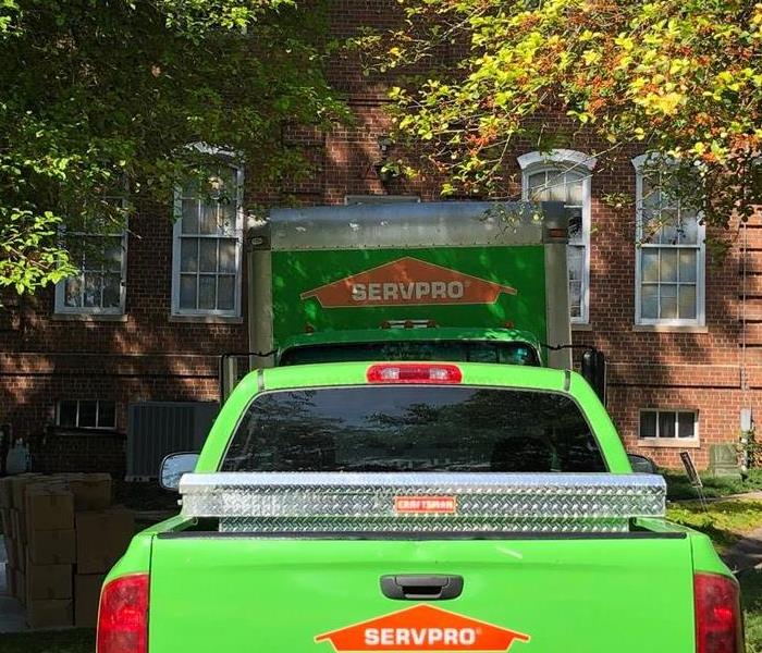 Two SERVPRO vehicles in a homeowners driveway.